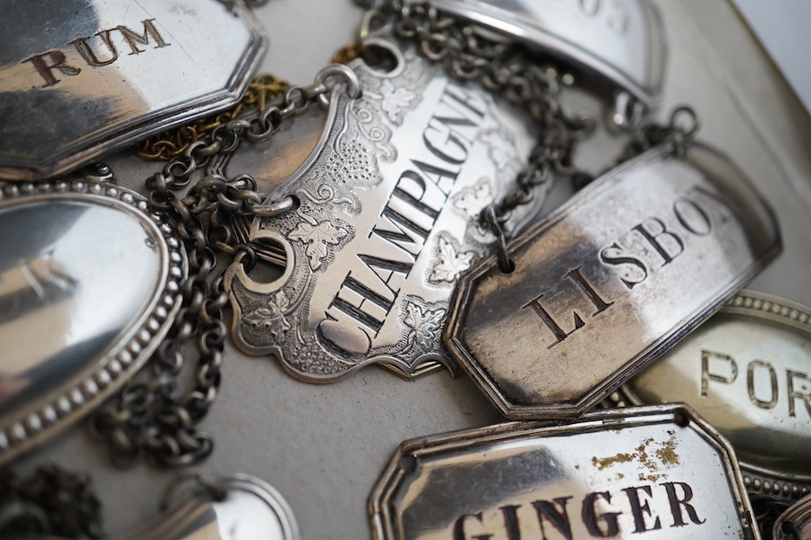 A collection of thirty two silver plated mostly named spirit labels, from the 19th century and 20th century, largest ‘Lisbon’ 6cm wide. Condition - a few where the plate has worn but most good